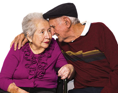 senior couple with their heads pressed against each other for memory care page
