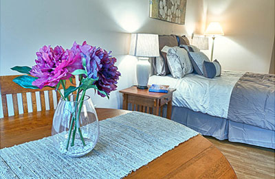 bedroom with colorful flowers sitting on a table schedule a tour and come see